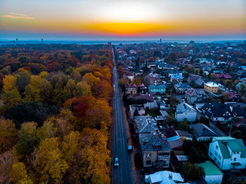 High angle view of buildings in city at sunset