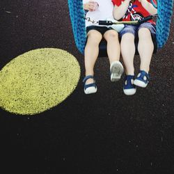 Low section of woman sitting outdoors