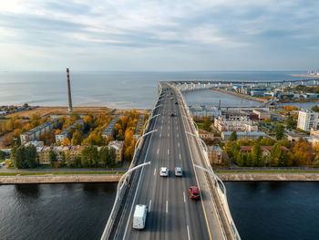 Aerial photo of cars driving on multilane highway. elevated bridge with high speed road above houses