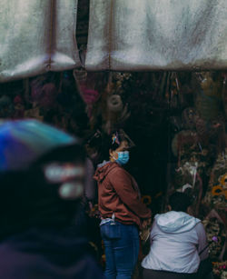 Rear view of people standing on street