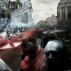 People photographing through glass window