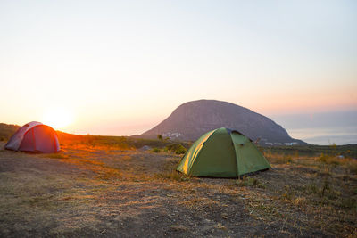 Installed tourist tent in the mountains with a view of the sea and sunrise. domestic tourism