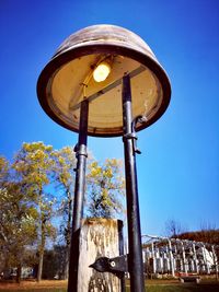 Low angle view of water tower against clear blue sky