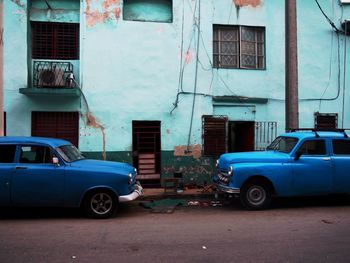 Car on street against old buildings