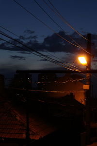 Electricity pylon against sky at night