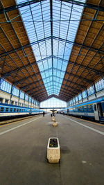 Rear view of man walking on railroad station