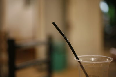 Close-up of drink with straw on table