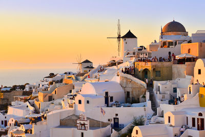 Golden hour, sunset at oia, santorini island, greece.  white houses over the caldera, aegean sea