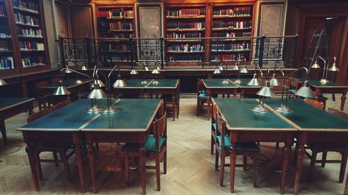 Empty chairs and tables in library