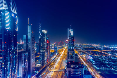 High angle view of illuminated buildings in city at night in dubai 