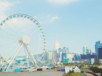 Ferris wheel in city against sky