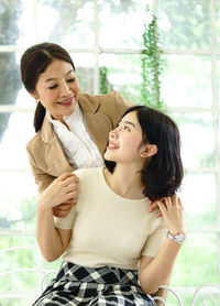 Young woman smiling while sitting outdoors