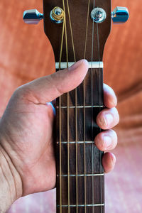 Midsection of person playing guitar