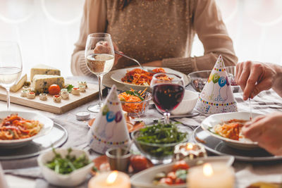 Midsection of woman having food in plate