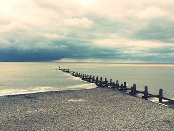 Scenic view of sea against cloudy sky