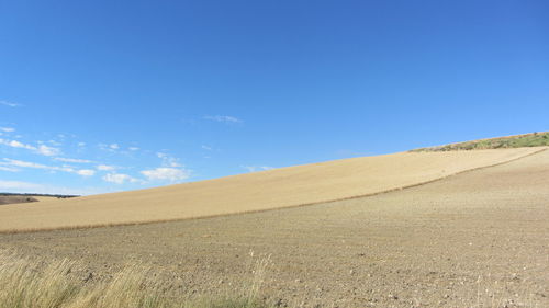 Scenic view of landscape against blue sky