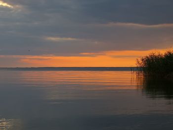 Scenic view of lake against sky during sunset