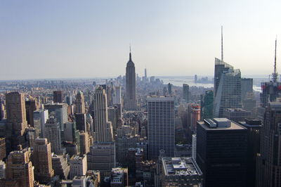 Empire state building with cityscape against sky