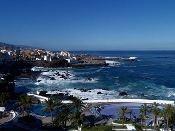 Scenic view of sea against clear blue sky