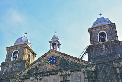 Low angle view of clock tower and building against sky