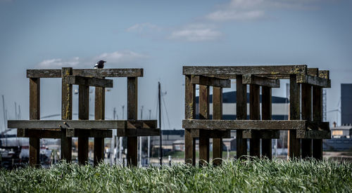 Old wooden structure on field against sky