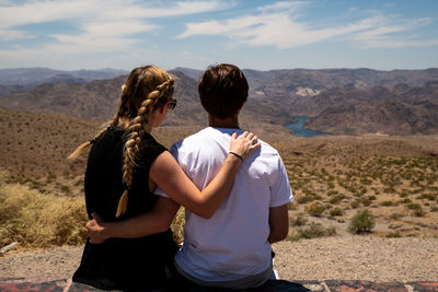 Rear view of women standing on landscape