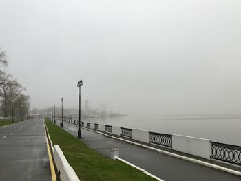 Street by road against sky