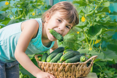 Portrait of young woman holding plant