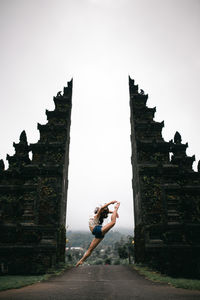 Low angle view of woman against sky