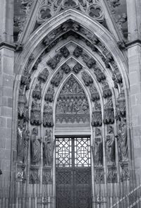 Monochrome photography of arched cathedral entrance in gothic style