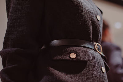 Midsection of man wearing leather jacket