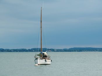 Sailboat sailing on sea against sky