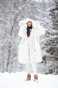 Portrait woman wearing fashionable warm clothes in winter nature. stylish fashion model in coat