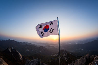 Scenic view of mountains against clear sky during sunset