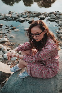 Woman sitting on rock