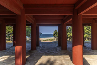 View of beach and sky seen through pavilion columns
