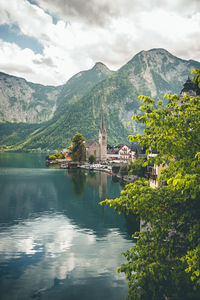 Scenic view of lake by mountains against sky