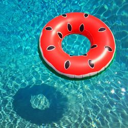 High angle view of red floating on swimming pool