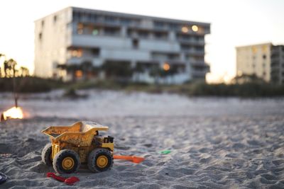 Toy car on street against sky