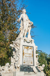 Low angle view of statue against blue sky