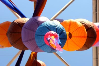 Low angle view of multi colored lanterns against sky