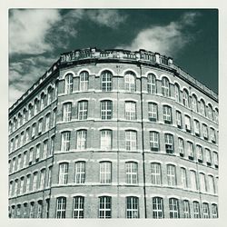 Low angle view of building against cloudy sky