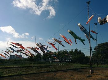 Low angle view of flags hanging against sky