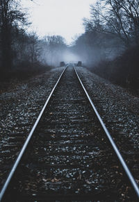 Surface level of railroad tracks against sky