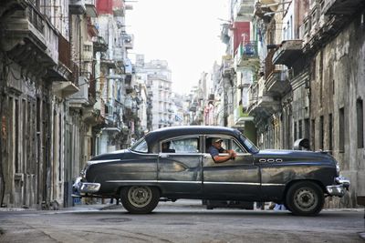 Cars on street amidst buildings in city