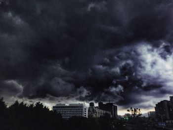 Low angle view of storm clouds over city