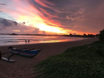 Scenic view of beach against sky during sunset