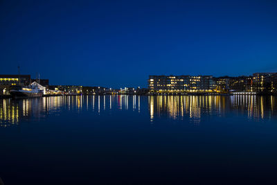 Reflection of illuminated buildings in water at night