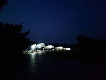 Scenic view of lake against sky at night