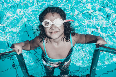 High angle portrait of girl in swimming pool